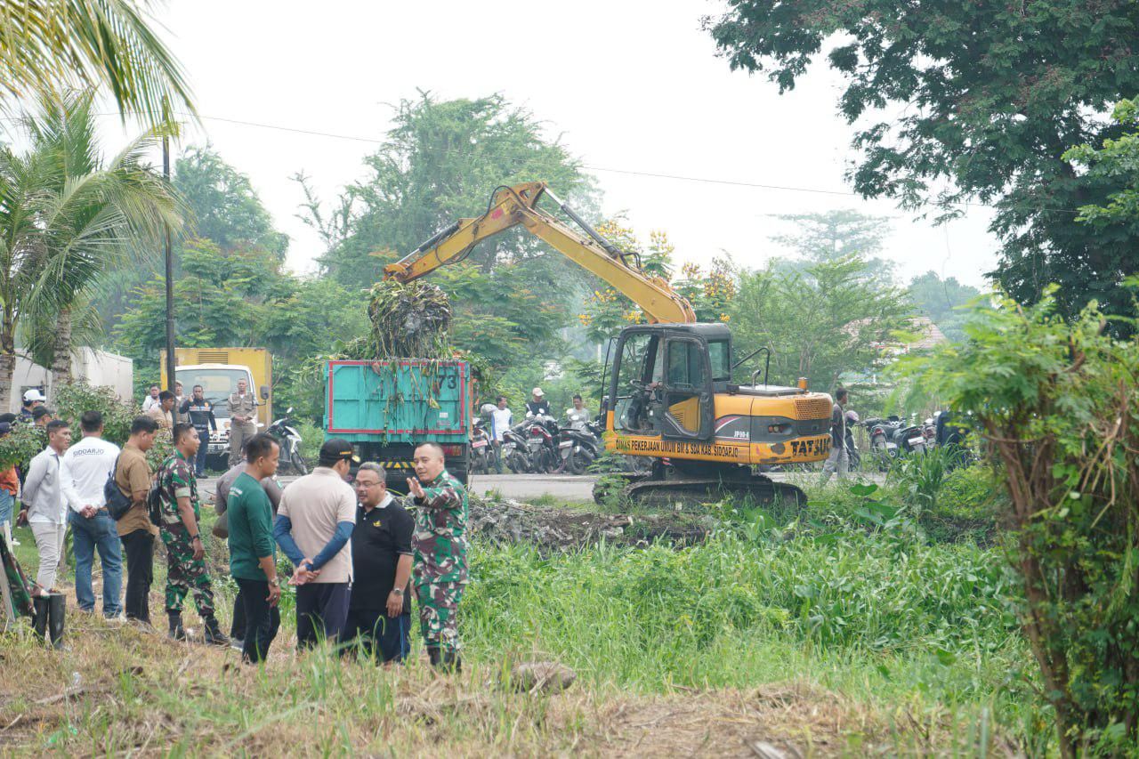 BERSIHKAN SUNGAI - Plt Bupati Sidoarjo, Subandi bersama Kodim 0816 dan sejumlah pejabat lain turun ikut bersih-bersih Sungai Wunut yang ada perbatasan Kecamatan Porong dan Kecamatan Tanggulangin, Jumat (03/01/2025).