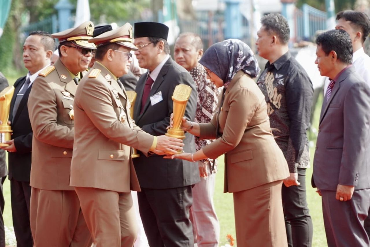 PENGHARGAAN - Plt Bupati Sidoarjo Subandi menerima penghargaan sebagai Pembina Keselamatan dan Kesehatan Kerja (K3) Terbaik Provinsi Jatim dari Pj Gubernur Adhy Karyono pada Apel Bulan K3 Nasional di lapangan Prapat Kurung, Surabaya, Senin (13/01/2025).