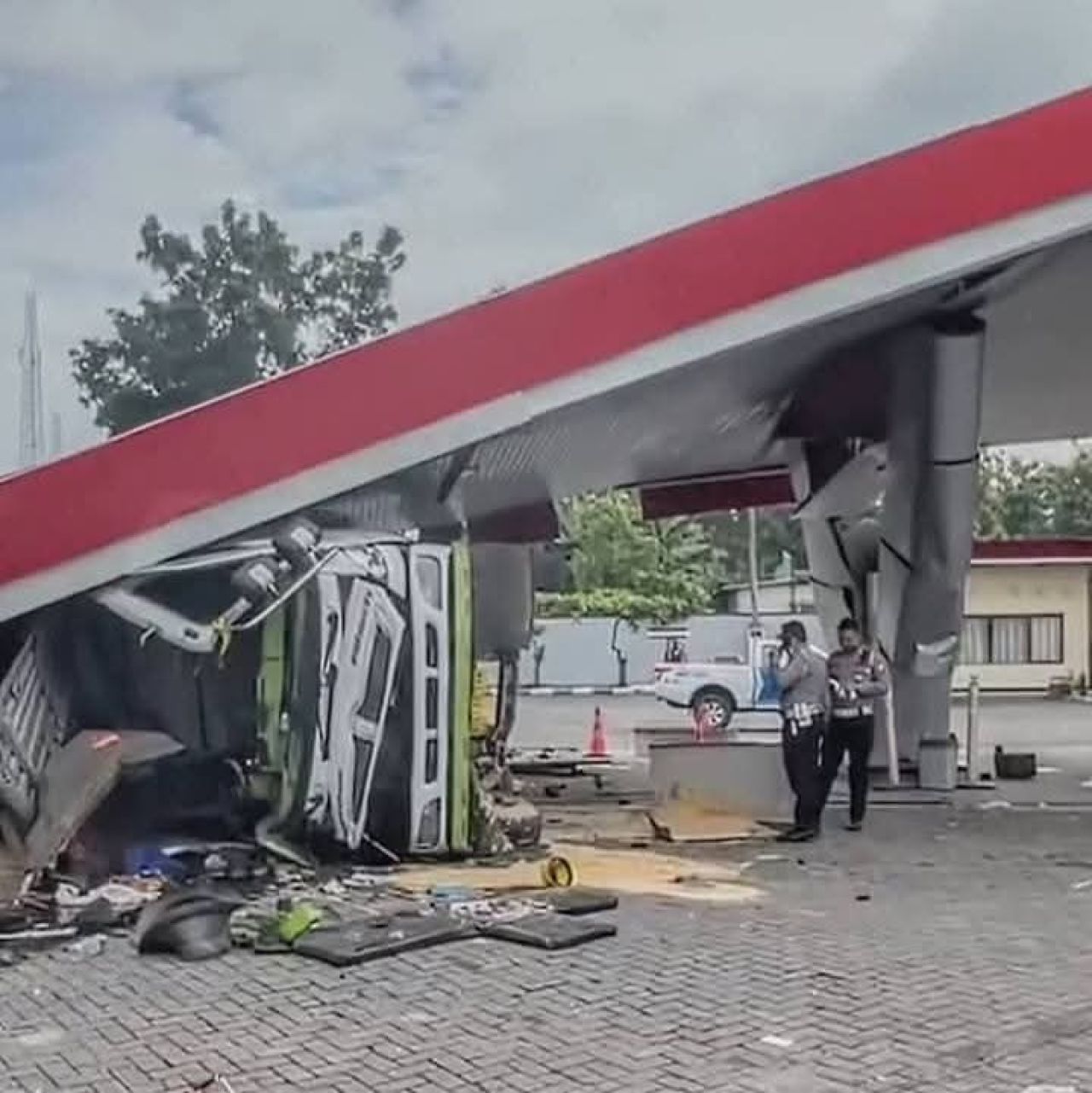 OLAH TKP - Petugas Unit Gakkum, Satuan Lantas, Polres Ngawi melaksanakan olah TKP kecelakaan truk tronton tabrak SPBU di JL Raya Dusun Joho, Desa Karangtengah Prandon, Kecamatan/Kabupaten Ngawi, Sabtu (22/03/2025).