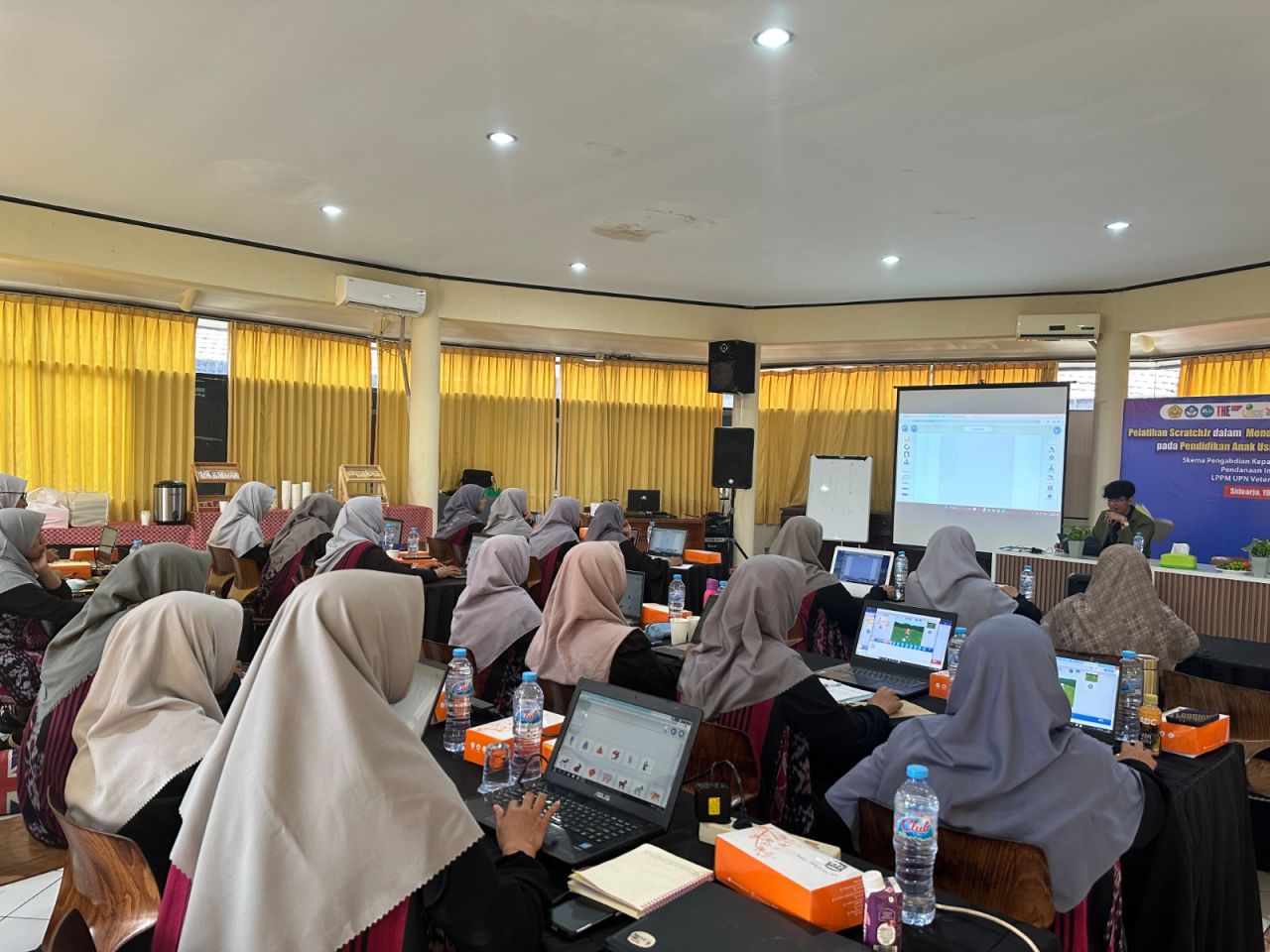 CODING - Para ustadzah KB TK Al Muslim mengikuti pelatihan ScratchJr mendukung kurikulum pemrograman Pendidikan Anak Usia Dini (PAUD) berkolaborasi dosen dan mahasiswa Fakultas Ilmu Komputer Program Studi Informatika UPN Veteran Jatim, Sabtu (19/07/2025).