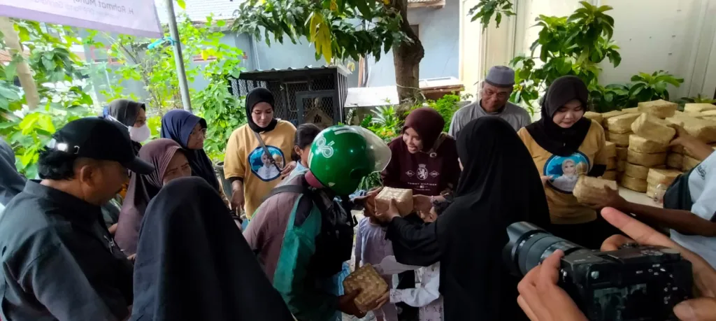 BERBAGI - Wabup Sidoarjo Hj Mimik Idayana S AP didampingi suaminya H Rahmat Muhajirin SH MH menyalurkan sebanyak 4.000 besek daging kurban kepada masyarakat sekitar rumahnya di depan rumahnya di Candi, Sidoarjo, Rabu (27/05/2026).