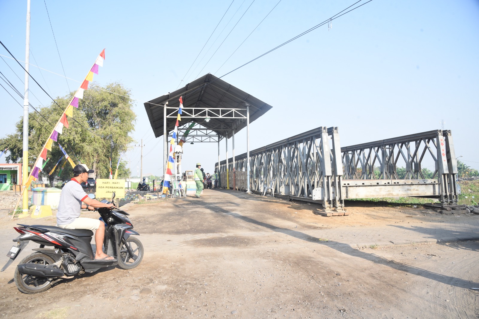 SELESAI - Pemasangan Jembatan Bailey di Desa Kedungpeluk, Kecamatan Candi, Sidoarjo mulai selesai dirakit akan tetapi masih menunggu proses pembangunan oprit dan pengaspalan, Jumat (16/08/2024).