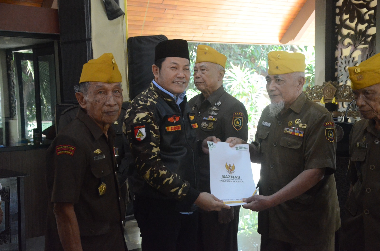 SANTUNAN - Plt Bupati Sidoarjo, Subandi menyerahkan santunan dari BAZNAS Sidoarjo untuk para veteran di Pendopo Delta Wibawa, Senin (19/08/2024).