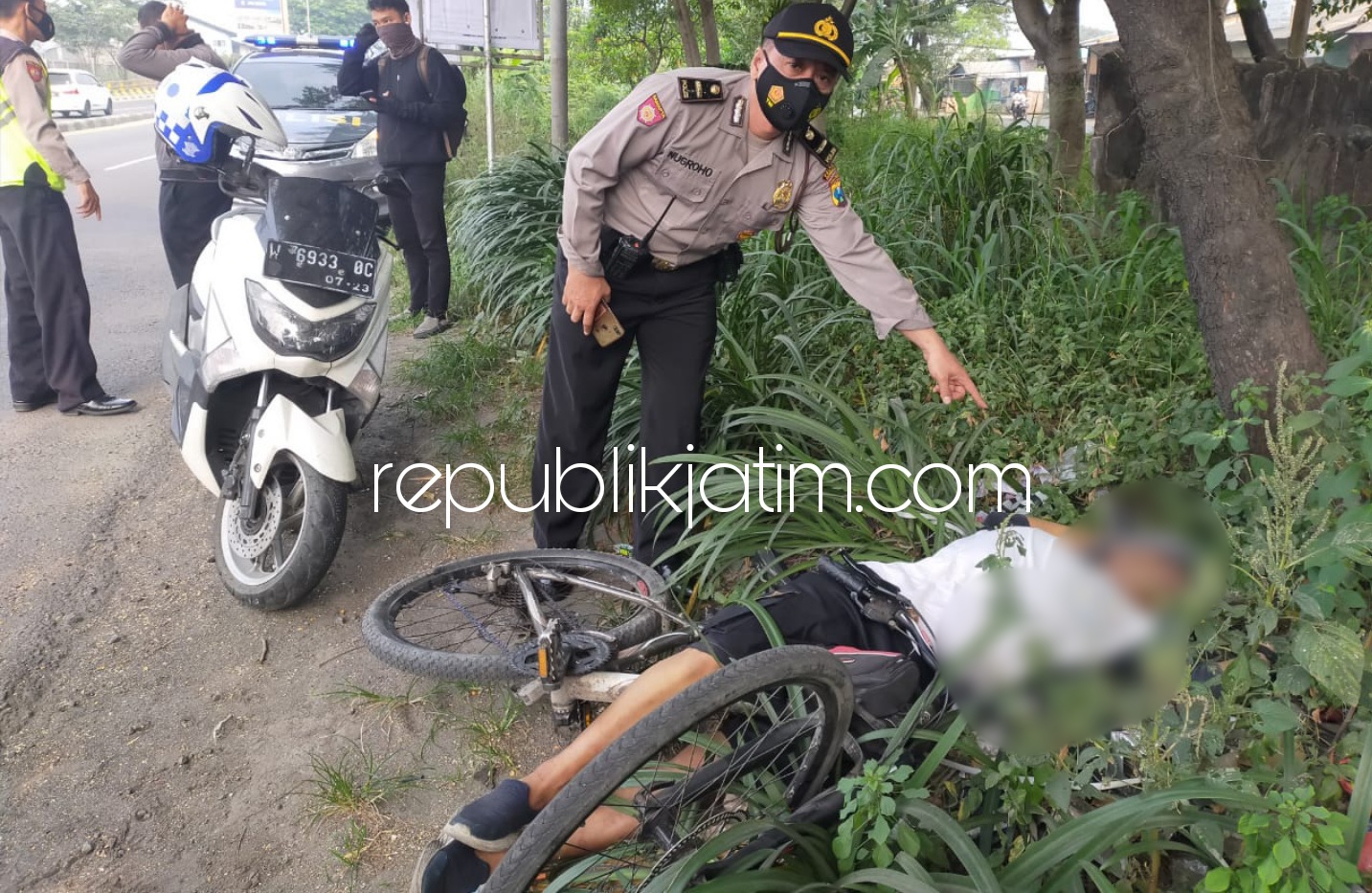 EVAKUASI - Pria yang diperkirakan berusia 55 tahun tewas di samping Fly Over (jembatan layang) Trosobo, Desa Bringinbendo, Kecamatan Taman, Sidoarjo, Minggu (23/05/2021).
