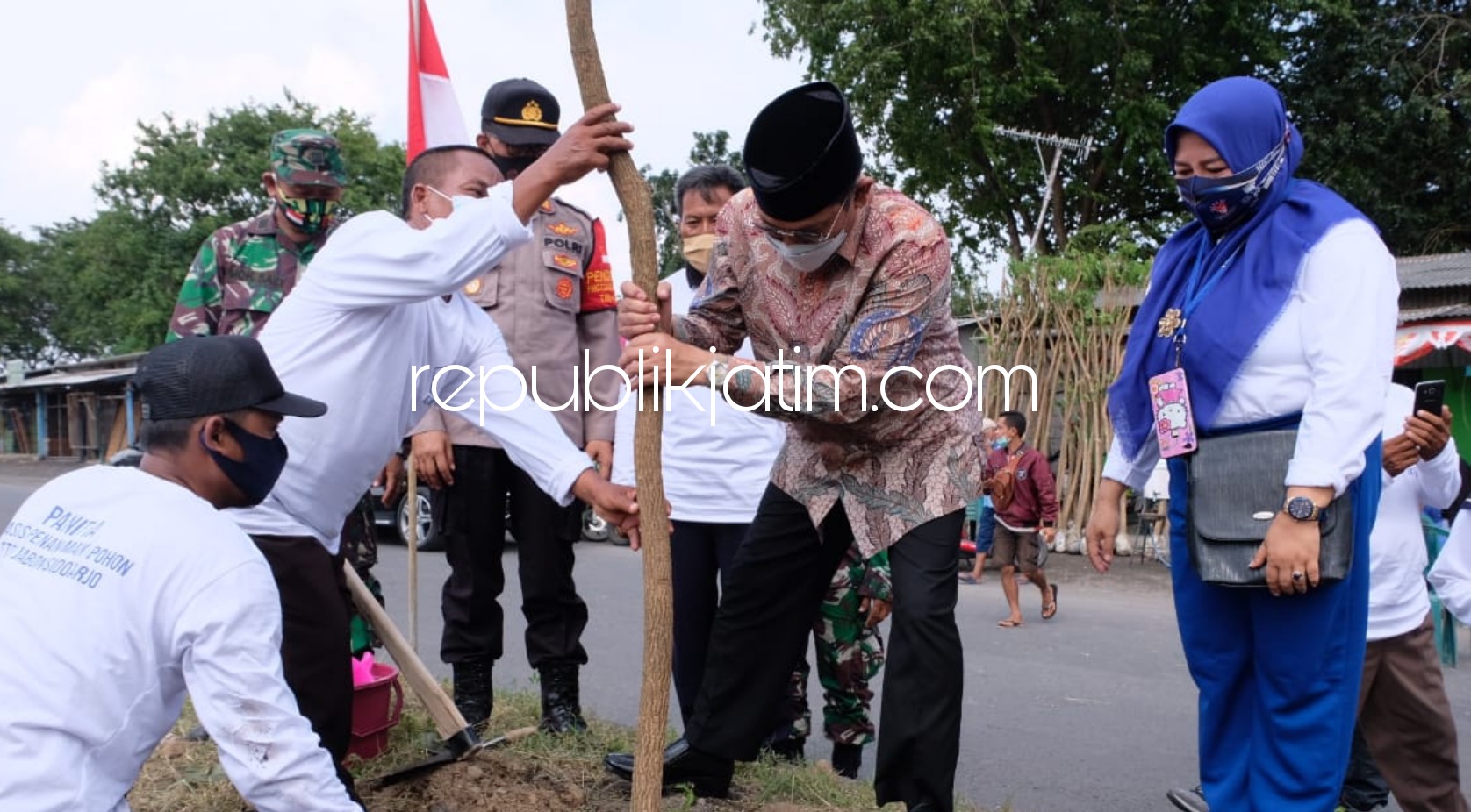 TANAM POHON - Pj Bupati Sidoarjo, Hudiyono didaulat pertama menanam pohon trembesi bersama PKL di sepanjang Exit Tol Jabon, Sidoarjo, Minggu (14/02/2021). 