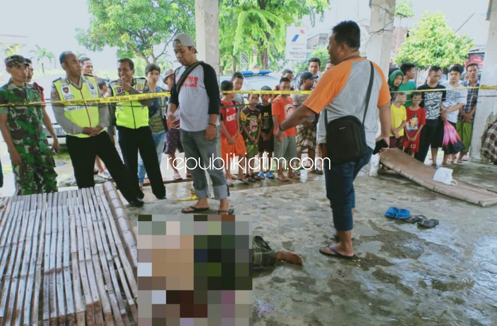 TEWAS - Petugas mengevakuasi korban pembacokan, Sakdullah (40) warga asal Dusun Krajan Tengah, Desa Semedusari, Kecamatan Lekok, Kabupaten Pasuruan yang tewas di Tempat Pelelangan Ikan (TPI) Desa Tambakoso, Kecamatan Waru, Sidoarjo, Minggu (23/02/2020).