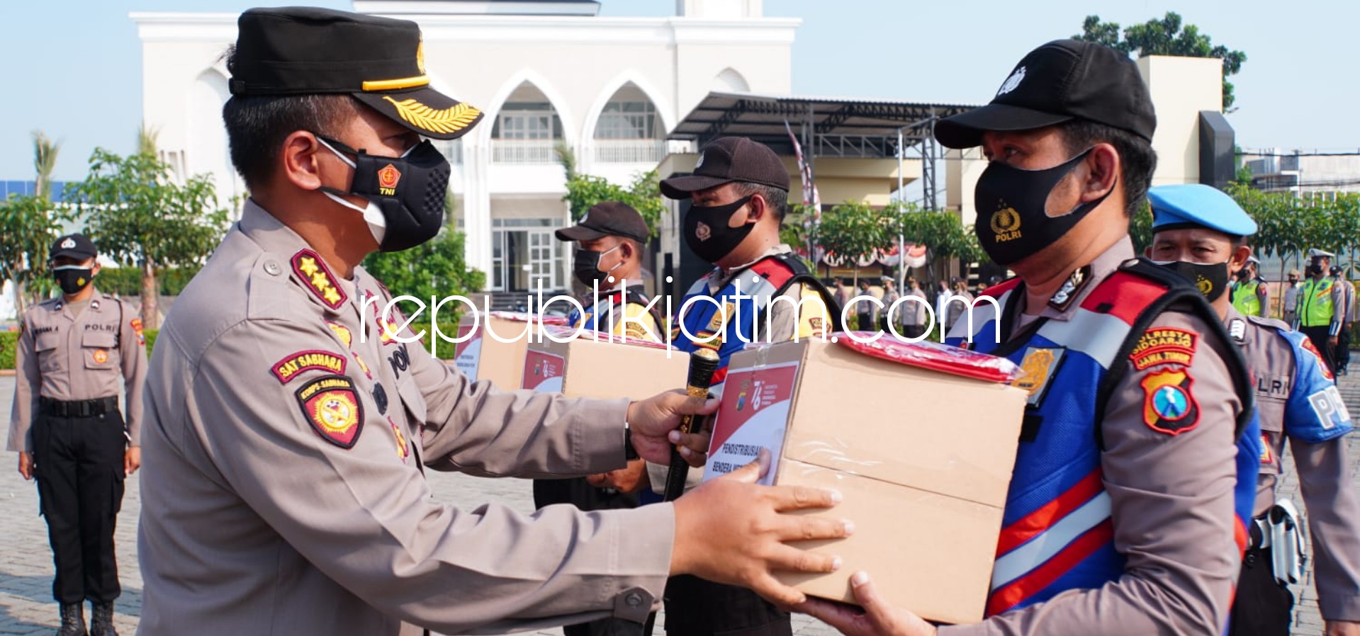 BAGIKAN - Kapolresta Sidoarjo, Kombes Pol Kusumo Wahyu Bintoro membagikan 5.000 bendera merah putih melalui Bhabinkamtibmas yang diberangkatkan dari halaman Polresta Sidoarjo, Senin (16/08/2021).