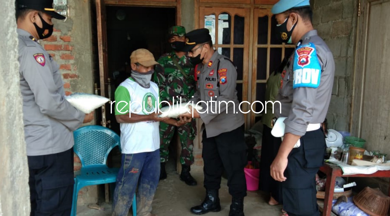 RUSAK - Kapolsek Sooko Iptu Badri dan anggotanya memberi bantuan kepada keluarga Kadhis warga Desa Jurug, Kecamatan Sooko, Ponorogo yang rumahnya rusak karena tanahnya ambles, Selasa (09/11/2021).