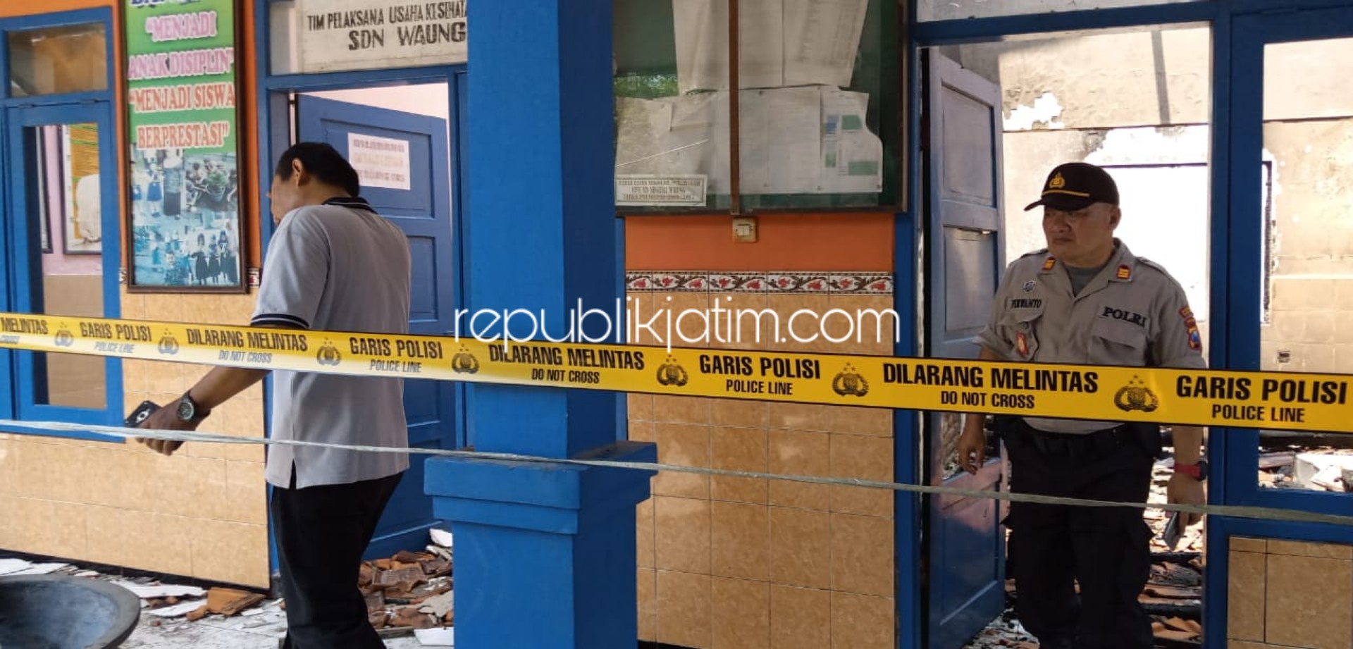 POLICE LINE - Kapolsek Krembung, AKP Purwanto dan Kanit Reskrim, Ipda Soepatman dan petugas Polresta Sidoarjo menggelar olah TKP pasca kebakaran SDN Waung, Kecamatan Krembung, Sidoarjo, Jumat (15/11/2019).