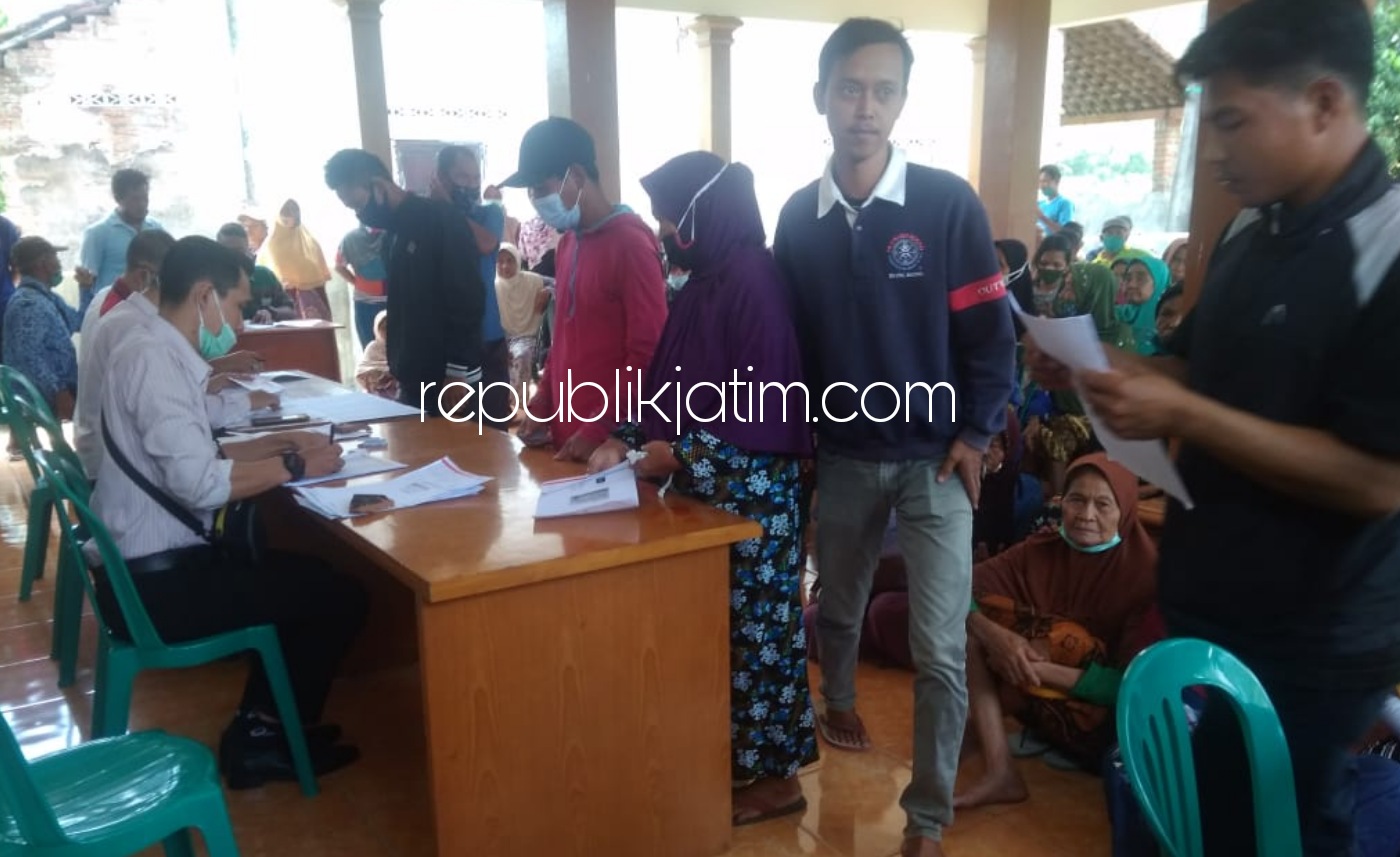 PENCAIRAN - Ratusan Keluarga Penerima Manfaat (KPM) antre menunggu pencairan Bantuan Langsung Tunai Dana Desa (BLT DD) di Balai Desa Munggu, Kecamatan Bungkal, Ponorogo, Selasa (17/11/2020).