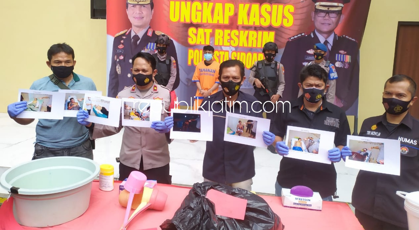DITAHAN - Tersangka kasus penyiraman air keras dengan 15 korban dilarikan ke Rumah Sakit Siti Khotidjah Sepanjang, Kecamatan Taman, Sidoarjo, Bagus Aji Santoso warga Lumajang ditahan petugas Polresta Sidoarjo beserta barang buktinya, Rabu (16/12/2020).