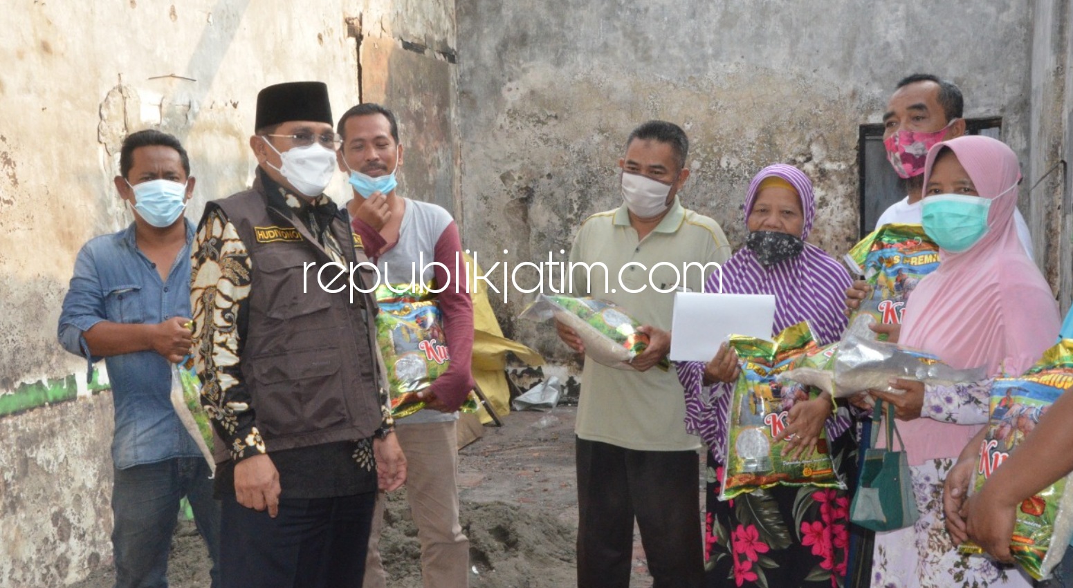 SERAHKAN - Pj Bupati Sidoarjo, Hudiyono menyerahkan bantuan kepada korban kebakaran Sunariyah warga JL Raya Luwung, Desa Sarirogo, Kecamatan Sidoarjo, Minggu (27/12/2020) sore. 