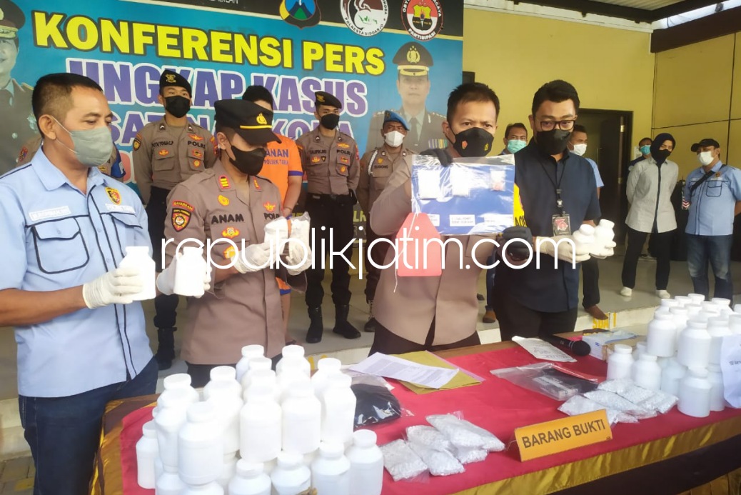 PENGEDAR - Kapolresta Sidoarjo, Kombes Pol Kusumo Wahyu Bintoro menginterogasi dan memamerkan tersangka pengedar narkoba jenis sabu-sabu dan 500.000 pil koplo yang ditangkap di kawasan Tarik bersama barang buktinya, Selasa (24/05/2022).