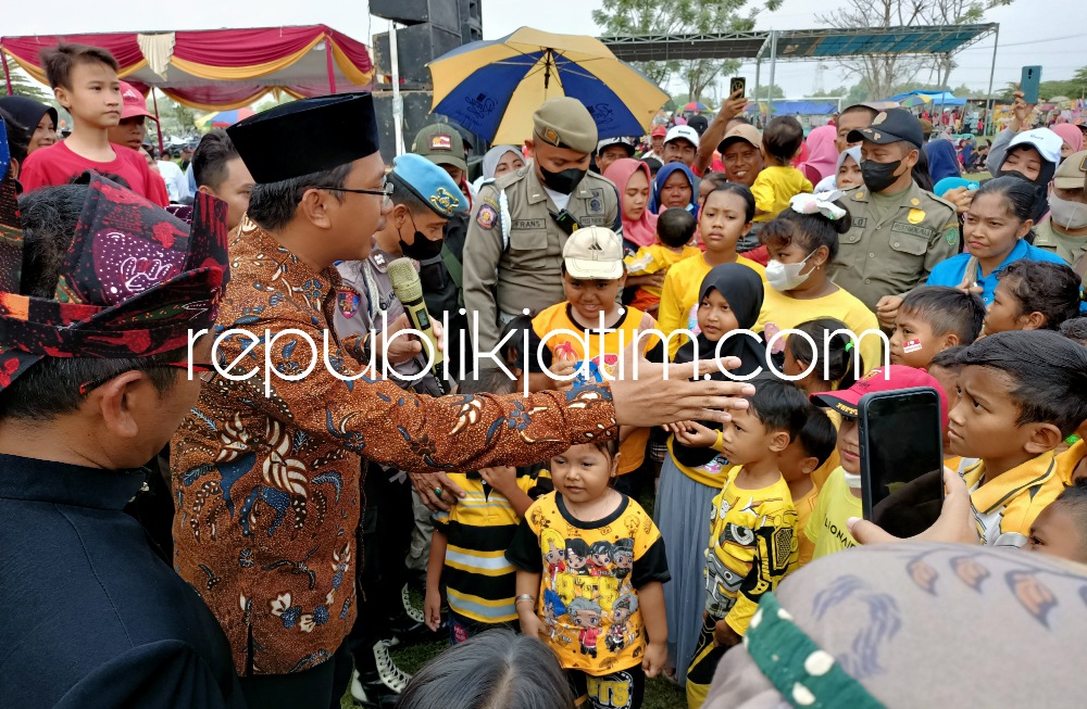HADIAH - Bupati Sidoarjo Ahmad Muhdlor Ali membagikan hadiah kepada puluhan anak-anak yang mengenakan baju warna kuning saat acara Karnaval dan Jalan Sehat di Lapangan Desa Grabagan, Kecamatan Tulangan, Sidoarjo, Minggu (11/09/2022).