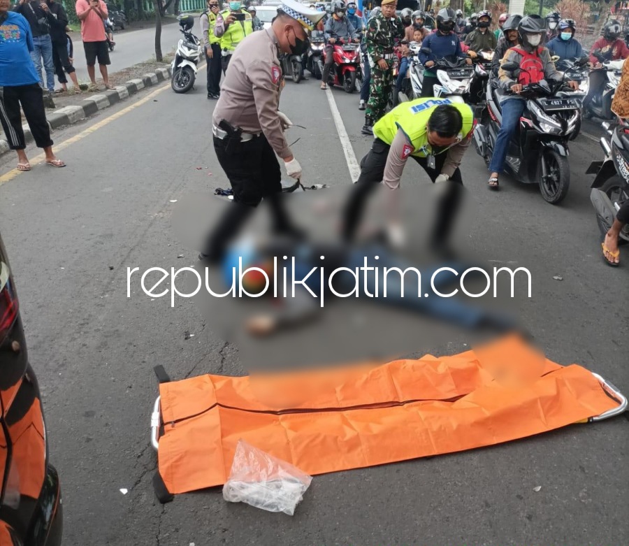 EVAKUASI - Petugas Lantas Polresta Sidoarjo mengevakuasi korban pengendara motor Honda Vario nopol W 5578 OG Joko Tri Prasetia warga Semambung, Kecamatan Wonoayu yang tergelatak di JL Raya Sruni, Kecamatan Gedangan, Sidoarjo Senin (26/12/2022).