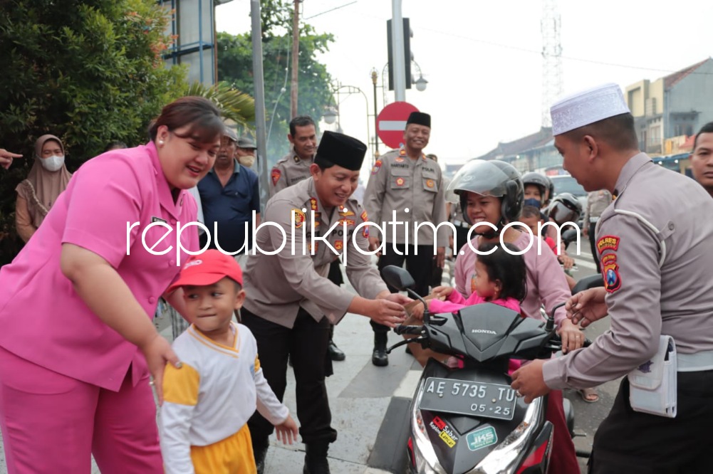 BAGI TAKJIL - Kapolres Ponorogo AKBP Catur Cahyono Wibowo bersama anak-anak TK dan ibu-ibu Bhayangkari membagikan makanan dan minuman takjil di perempatan Pasar Legi Ponorogo, Sabtu (25/03/2023) petang.
