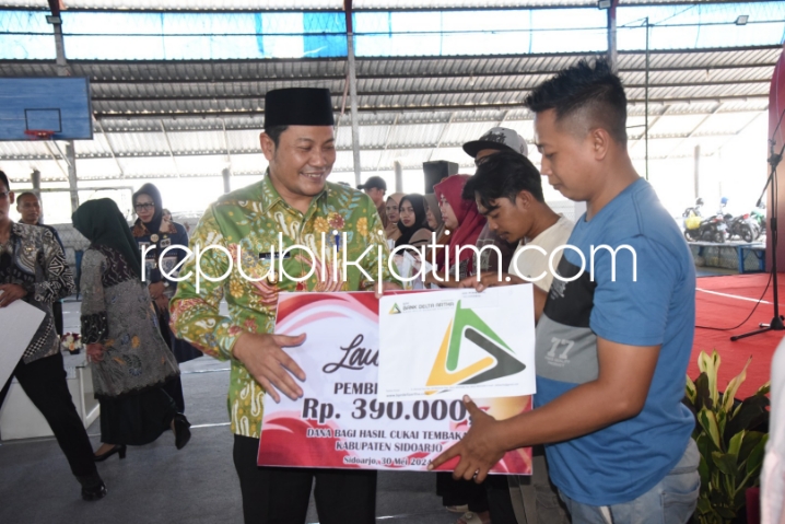 BLT - Plt Bupati Sidoarjo, Subandi secara simbolis menyerahkan BLT DBHCHT kepada 5.011 buruh pabrik rokok di Lapangan Fatkhi Futsal Centre Desa Ketegan, Kecamatan Tanggulangin, Sidoarjo, Kamis (30/05/2024).
