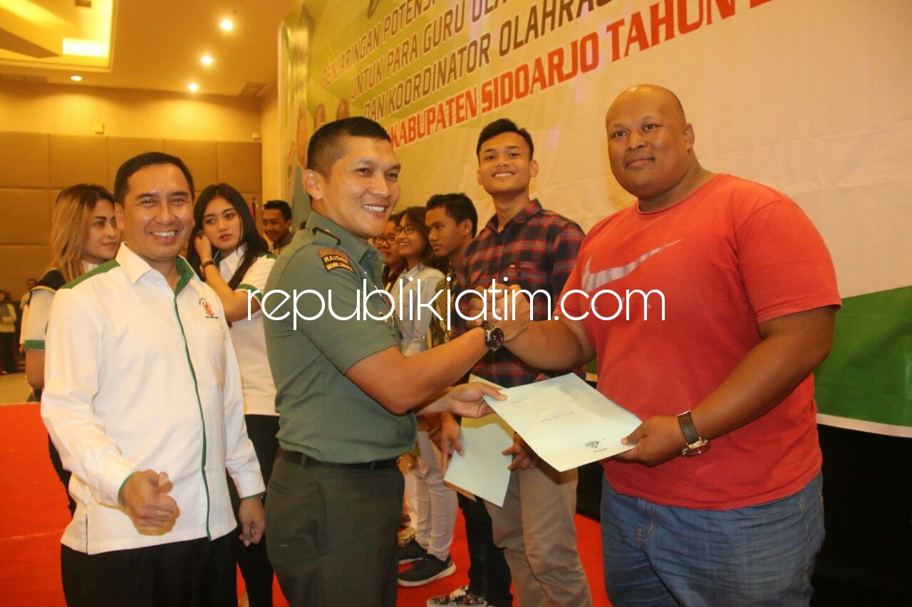 BANTUAN - Ketua KONI Sidoarjo, M Franky Effendi bersama Komandan Kodim 0816, Letkol Inf Fadli Mulyono menyerahkan bantuan ke para atlet berprestasi disela acara Workshop di Hotel Sun City Sidoarjo, Rabu (20/12/2017).